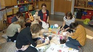 Parents and children in hospice playroom