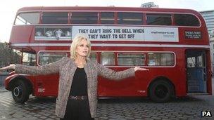 Joanna Lumley in front of double decker bus