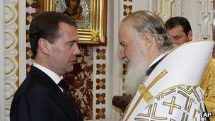 Patriarch Kirill (R) congratulates Russian President Dmitry Medvedev at a Christmas Eve service in Moscow's Christ The Saviour Cathedral, 6 January