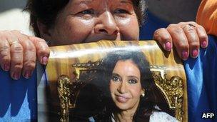 A supporter of Argentine President Cristina Fernandez de Kirchner waits with her poster outside the Austral Hospital in Pilar, Buenos Aires on Wednesday as she underwent surgery for thyroid cancer