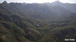 Military helicopter flies over marijuana plantations in the mountains of Sinaloa, December 2011