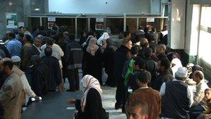 Customers face long queues at the banks to get their money out