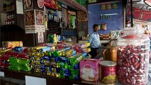 An Indian shopkeeper in his store