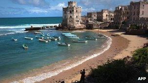 An African Union soldier taking a photo of a cove in Mogadishu in August 2011