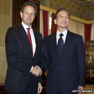 US Treasury Secretary Timothy Geithner (L) shakes hands with Chinese Premier Wen Jiabao ahead of a meeting in Beijing, 11 January 2012