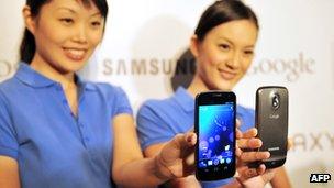 Models holding Samsung Galaxy Nexus phones