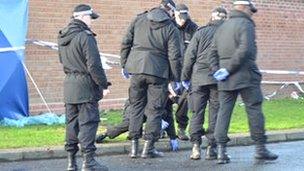 Officers searching the scene in Handsworth Wood