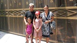 Lê Thanh with his wife and children at his old orphanage on a trip back to Vietnam