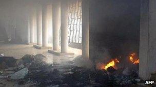 Fire rises at the Benin Central Mosque after an attack by youths on 10 January 2012