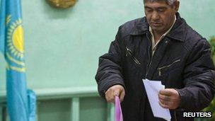 man casts his ballot in the village of Kosmos, east of Almaty. Photo: 15 January 2012