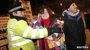 Police officer removes a protester from Parliament Square