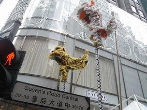 A lion dance performance outside a Coach store in Hong Kong's central business district