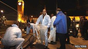 Police officers clear the tents