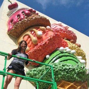 Suzanne Battle stands in front of the styrofoam ice cream outside her shop