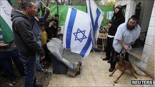 Jewish settlers argue with protesters in front of their house in the Sheikh Jarrah neighborhood of East Jerusalem.