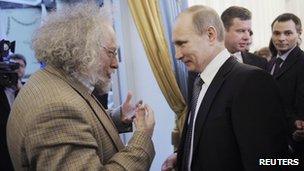 Russian journalist Alexei Venediktov (left) talks to Russian Prime Minister Vladimir Putin at a media awards ceremony in Moscow, 13 January