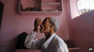 A tuberculosis patient takes medicines in India