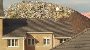 House with rubbish behind it - archive image