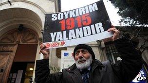 A Turkish man holds a placard reading "Genocide is a lie" in front of the French Consulate in Istanbul, 23 December 2011