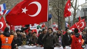 Turkish citizens from France and other European countries demonstrate in Paris Saturday Jan. 21, 2012, to protest against a law that makes it a crime to deny genocide against Armenians