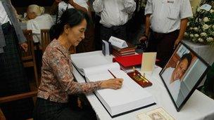 Aung San Suu Kyi signs the condolence book for Dr Nay Win Maung