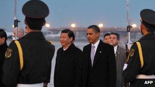US President Barack Obama, right, greeted by Chinese Vice President Xi Jinping at Capital International Airport in Beijing on 16 November 2009