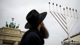 A Jewish man in front of a large menorah at the Brandenburg Gate in Berlin, Germany (file image)