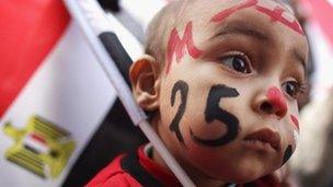 A baby wearing facepaint in Tahrir Square, Cairo (25 Jan 2012)