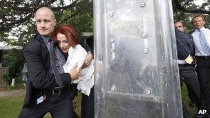 Prime Minister Julia Gillard, second from left, is escorted to safety by bodyguards in Canberra on 26 January 2012