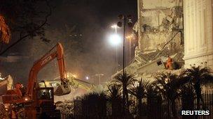 Firefighters work among the debris of a collapsed building in Rio de Janeiro