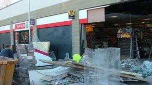 Supermarket's smashed wall