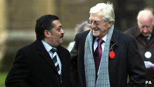 Sir Michael Parkinson (right) is greeted by Damian D'Oliveira, son of Basil D'Oliveira, as they arrive for the service. Photo: David Davies/PA Wire