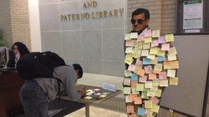 A cardboard cut out of Joe Paterno cover in post-its