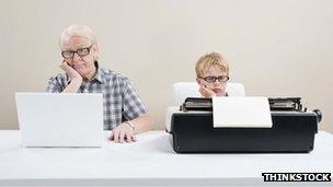 Man on laptop, boy on typewriter