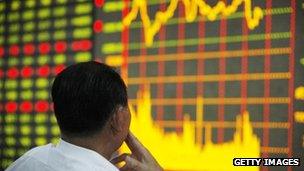 Investor looking at stock market board