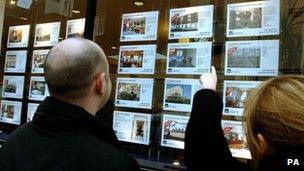 Couple outside estate agent