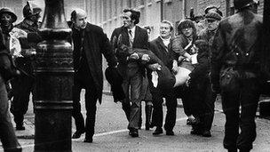 People carrying body of injured man on Bloody Sunday