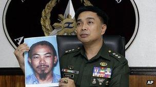 Armed Forces of the Philippines spokesman Col. Marcelo Burgos shows a picture of Malaysian Zulkipli bin Hir, also known as Marwan, a top leader of Jemaah Islamiyah, during a press conference Thursday, Feb. 2, 2012 in suburban Quezon City, north of Manila, Philippines.