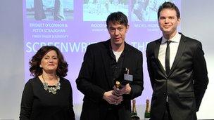 Peter Straughan (centre) with his Rafa award, flanked by awards hosts Hilary Oliver and James King