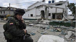 Police officer in front of wrecked police station in Villa Rica. 2 Feb 2012