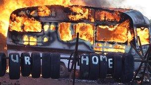 Flames engulf a caravan during evictions from Dale Farm travellers camp on 19 October, 2011