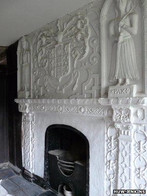 Decorative plaster work above the fireplace at Plas Tirion