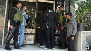 Egyptian soldiers stand guard in front of the offices of a non-governmental organisation in Cairo on 29 Dec 2011