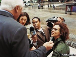 Press pack interviews man on steps