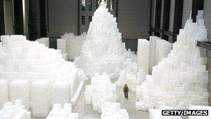 A woman walks through Rachel Whiteread's Embankment installation in the Tate Modern Gallery