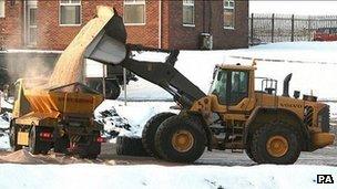 A digger fills a truck with rock salt - generic image