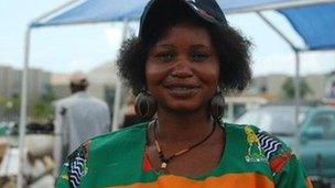 A Zambian woman adorned in the national colours of red, black and green