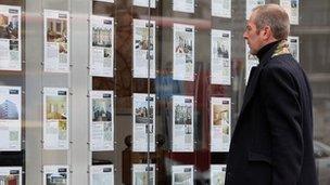 Man at estate agent window