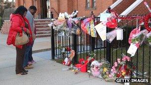 People view a makeshift memorial outside The New Hope Baptist Church in Newark, New Jersey 13 February 2012