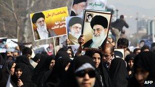 Pro-government demonstrators in Tehran hold up photographs of Ayatollah Ali Khamenei (February 2011)